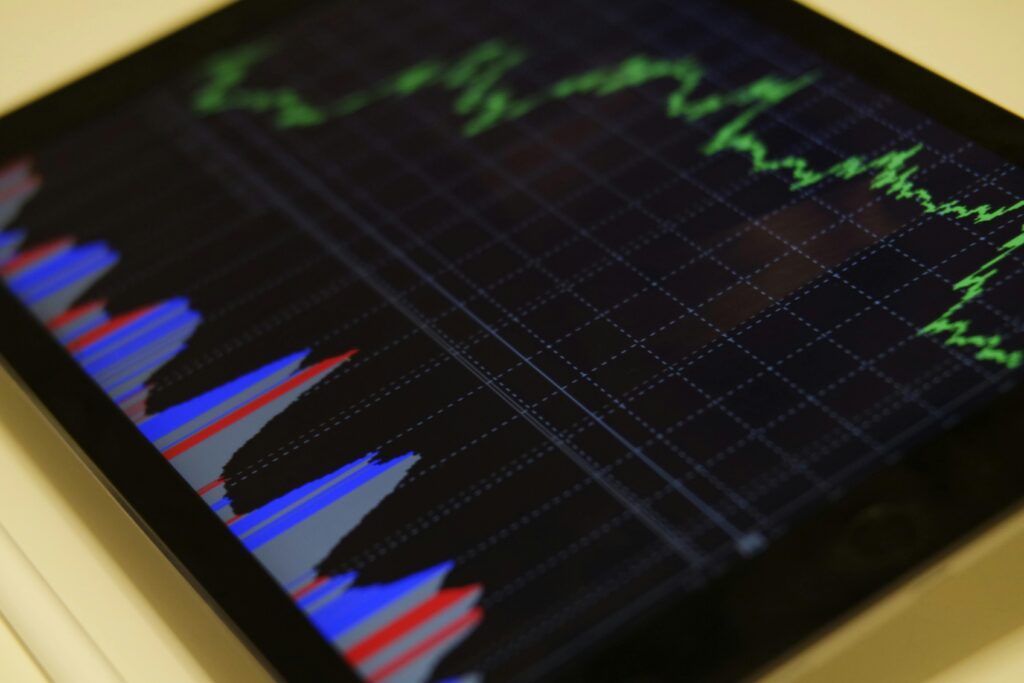 Tablet screen displaying colorful data charts and green line graphs, representing analytics and performance metrics.